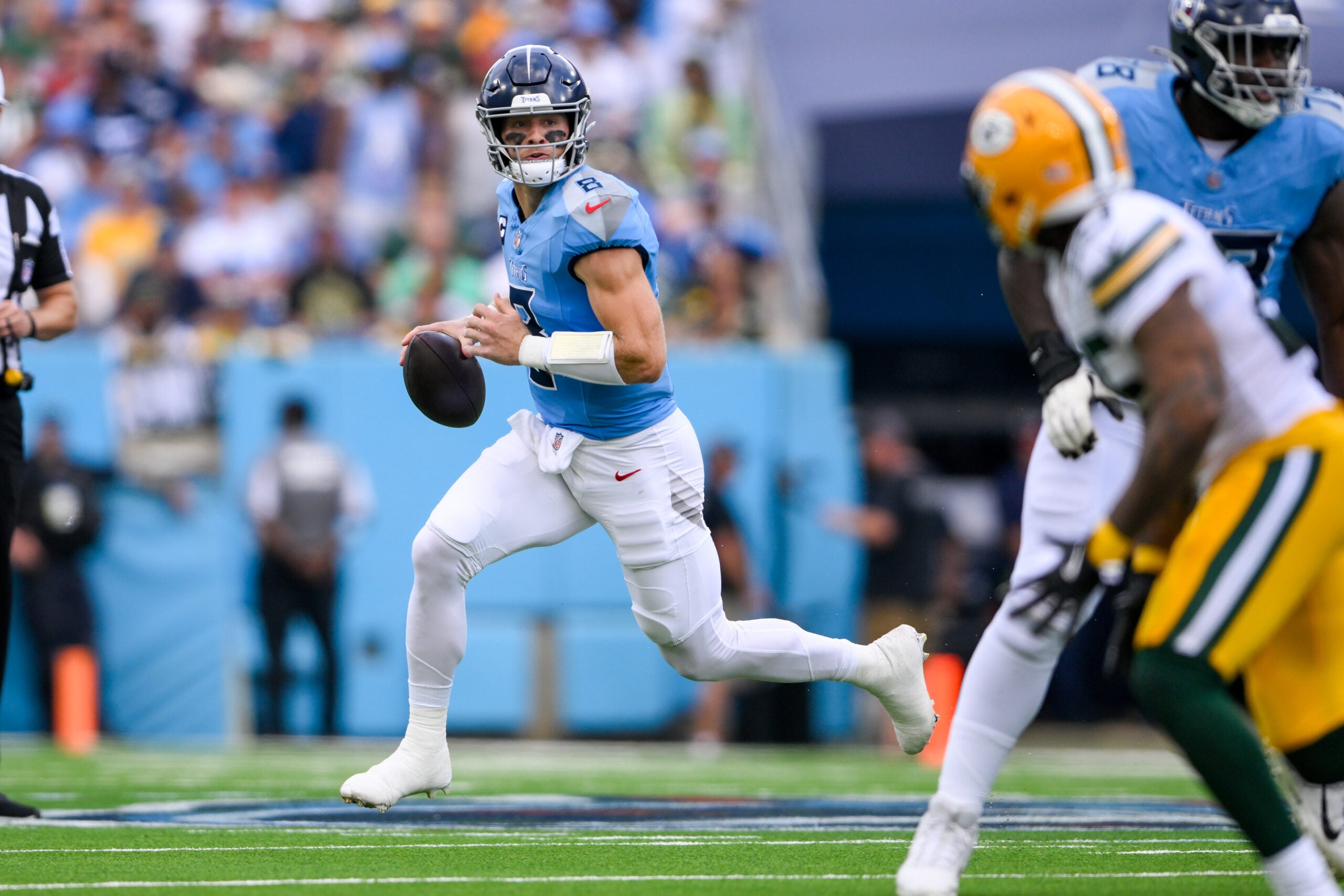 Sep 22, 2024; Nashville, Tennessee, USA; Tennessee Titans Will Levis (8) scrambles against the Green Bay Packers during the first half at Nissan Stadium.