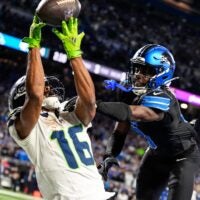 Detroit Lions cornerback Terrion Arnold (0) breaks a pass intended for Seattle Seahawks wide receiver Tyler Lockett (16) during the second half at Ford Field in Detroit on Monday, Sept. 30, 2024.