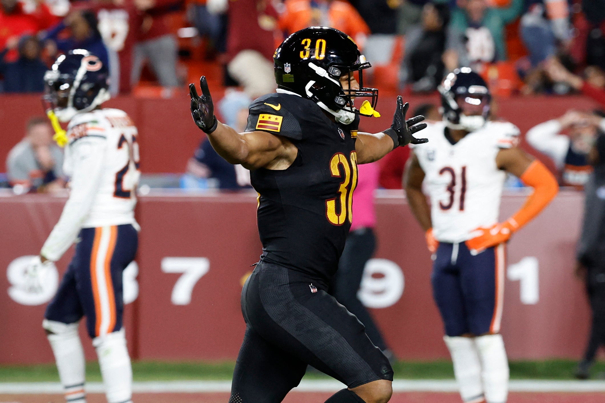 Oct 27, 2024; Landover, Maryland, USA; Washington Commanders running back Austin Ekeler (30) celebrates after the final play of the game against the Chicago Bears at Northwest Stadium.