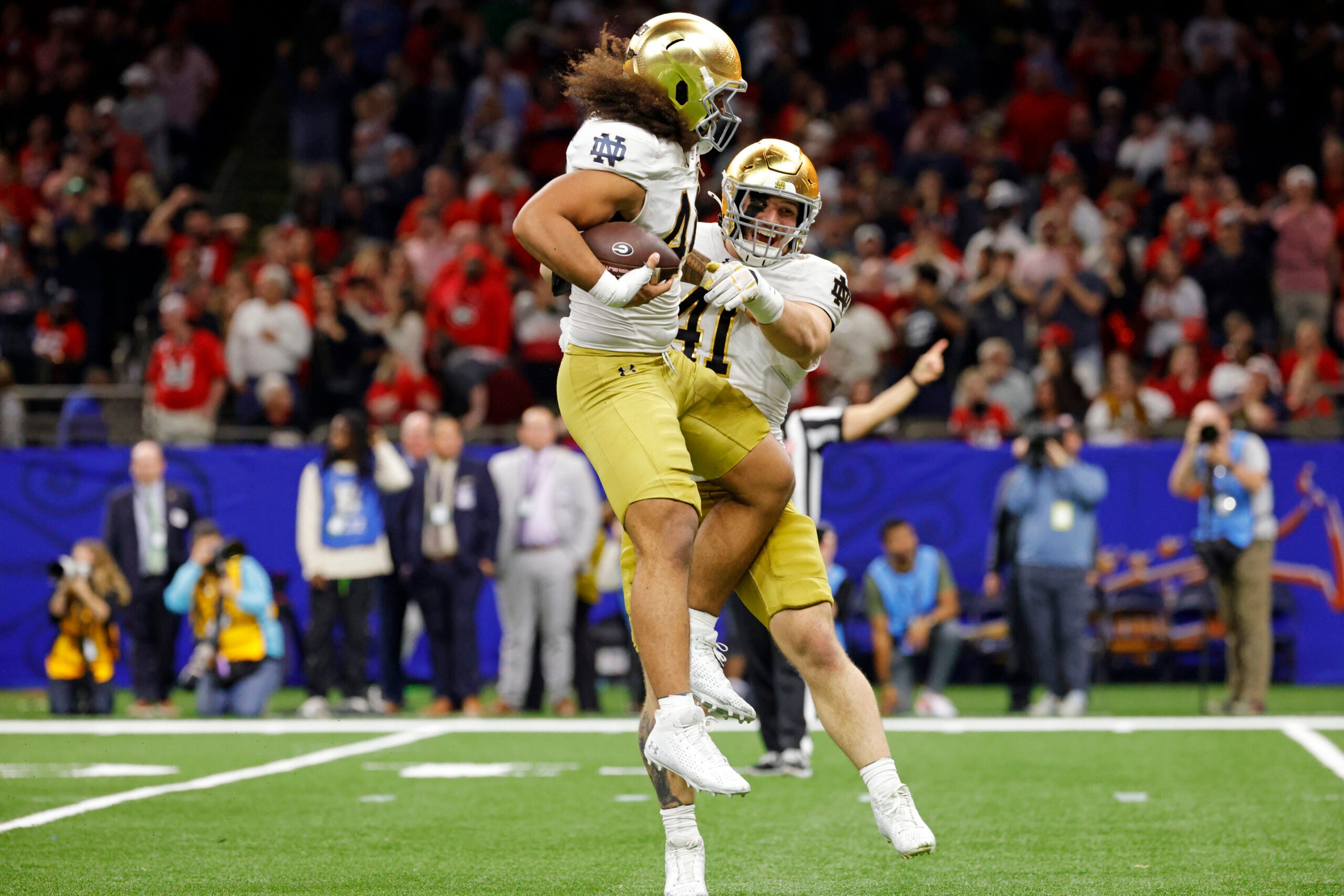 Jan 2, 2025; New Orleans, LA, USA; Notre Dame Fighting Irish defensive lineman Junior Tuihalamaka (44) reacts with Notre Dame Fighting Irish defensive lineman Donovan Hinish (41) after recovering a fumble during the second quarter after the game during the first half at Caesars Superdome.