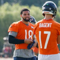 Jul 23, 2025; Lake Forest, IL, USA; Chicago Bears quarterback Caleb Williams (18) chats with quarterback Tyson Bagent (17) during training camp at Halas Hall.