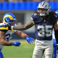 Aug 9, 2025; Inglewood, California, USA; Dallas Cowboys linebacker Marist Liufau (35) grabs a hold of Los Angeles Rams running back Cody Schrader (32) following a play inthe first half at SoFi Stadium.