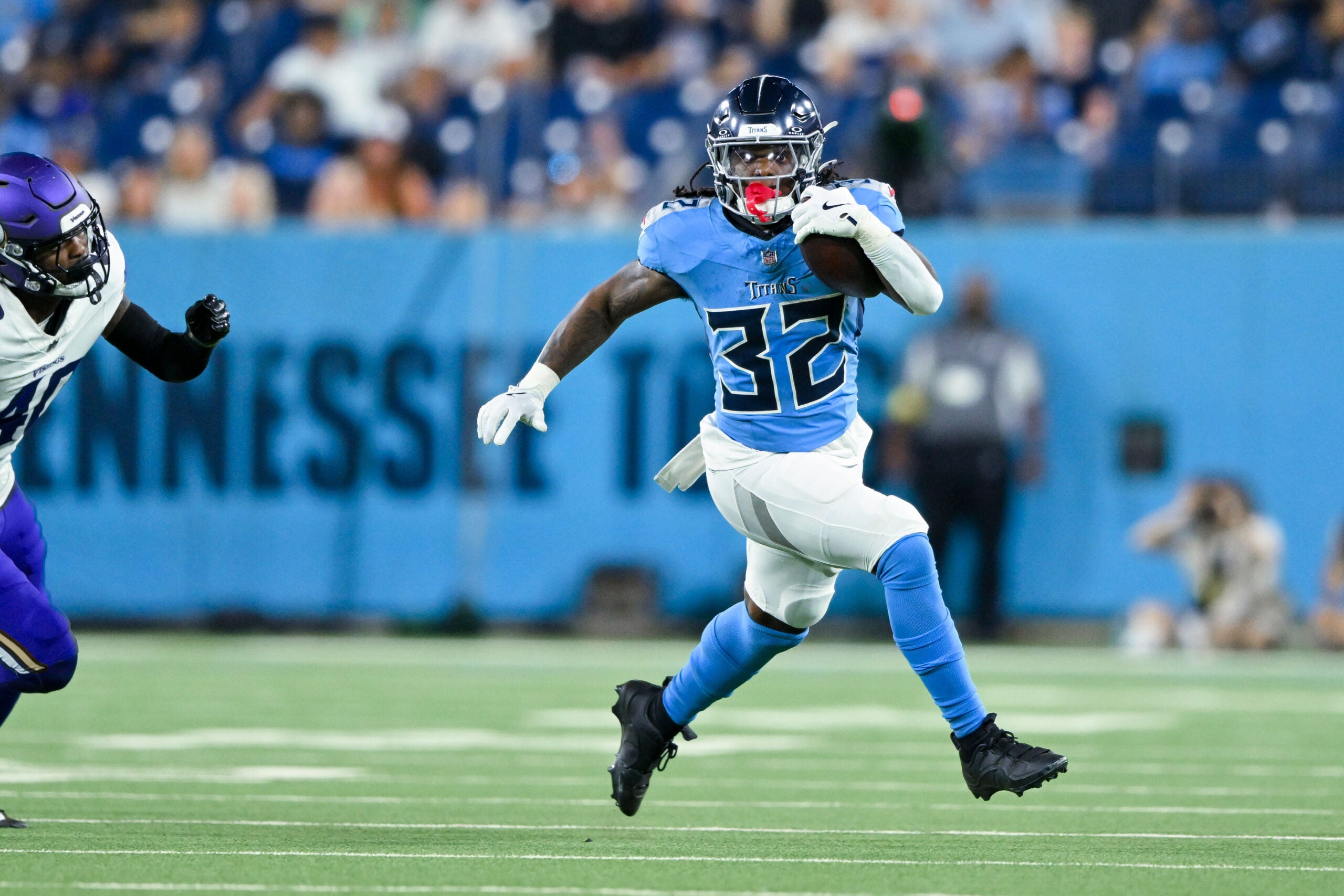 Aug 22, 2025; Nashville, Tennessee, USA; Tennessee Titans running back Jermar Jefferson (32) runs with the ball against the Minnesota Vikings during the second half at Nissan Stadium.