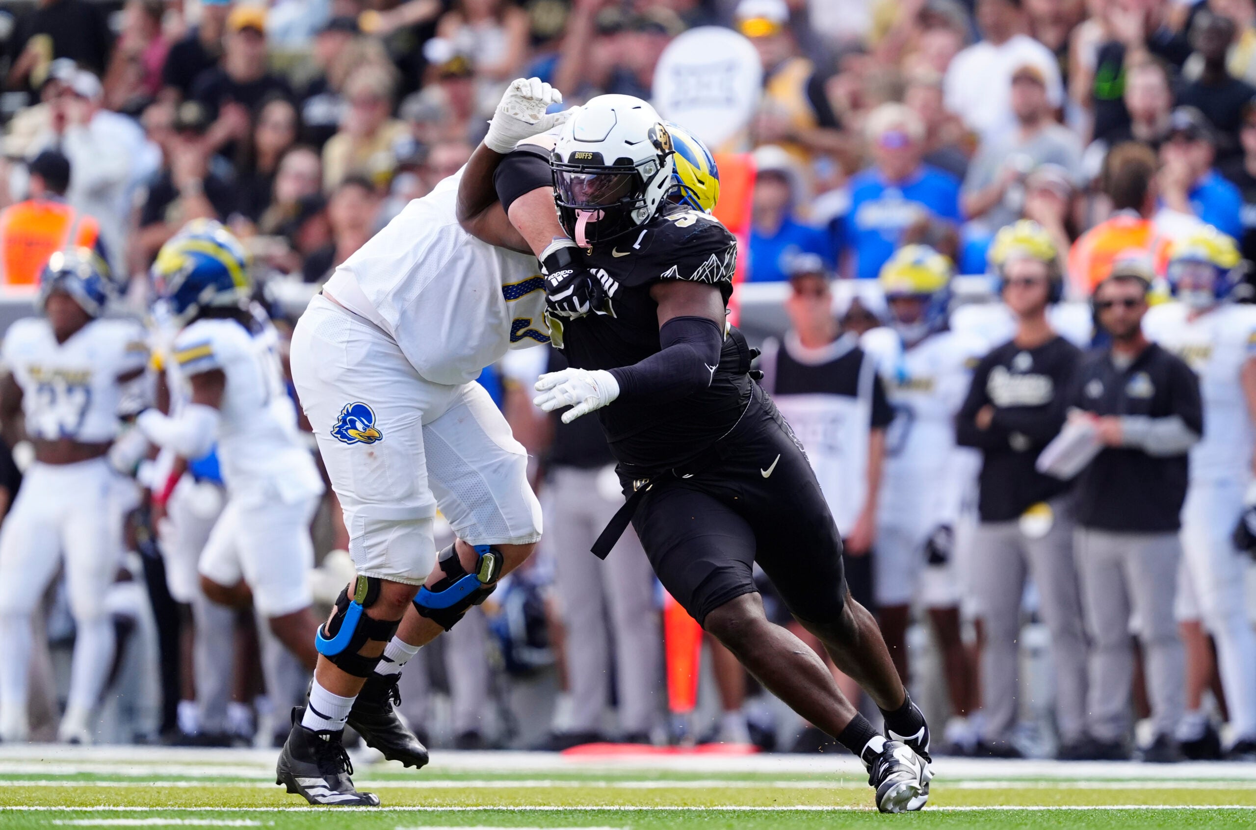 Sep 6, 2025; Boulder, Colorado, USA; Delaware Fightin Blue Hens offensive lineman Cole Snyder (77) holds Colorado Buffaloes defensive end Arden Walker (53) in the second half at Folsom Field.