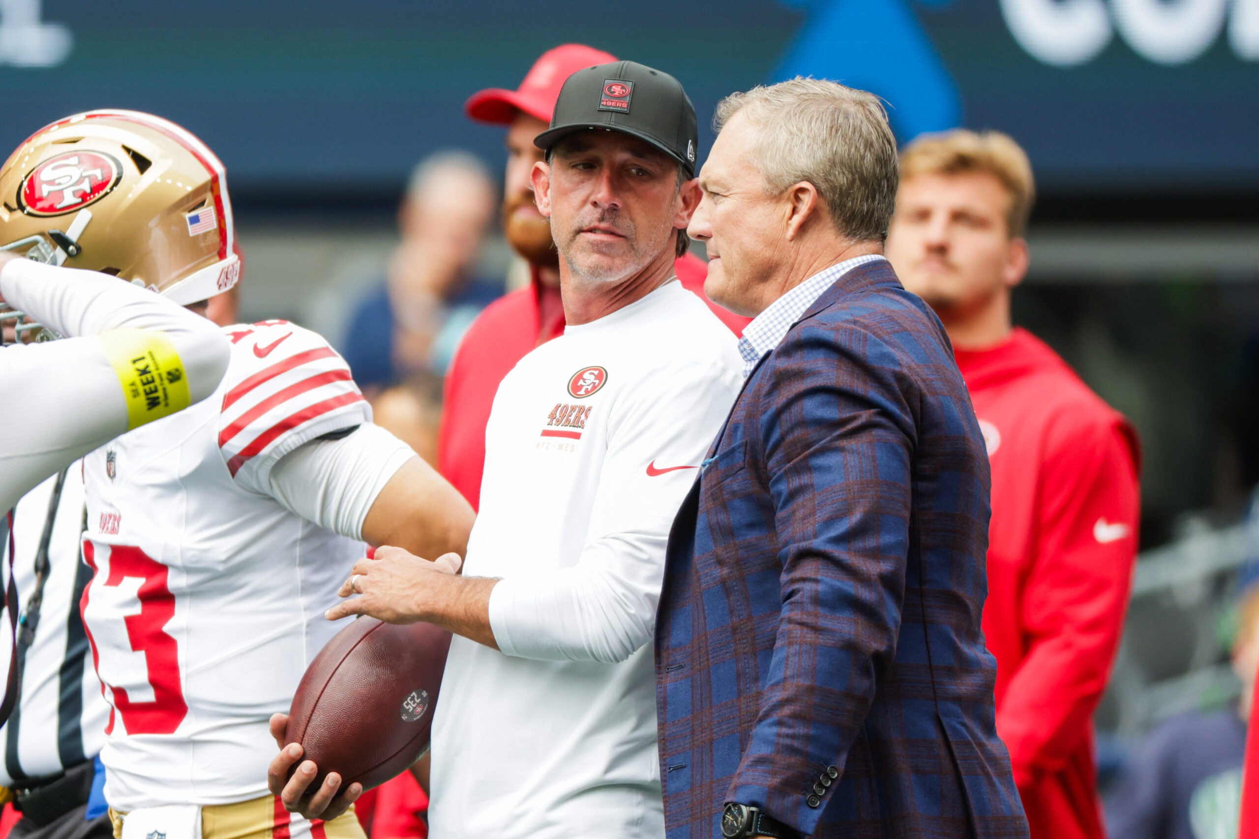 Sep 7, 2025; Seattle, Washington, USA; San Francisco 49ers general manager John Lynch, right, talks with head coach Kyle Shanahan during pregame warmups against the Seattle Seahawks at Lumen Field.