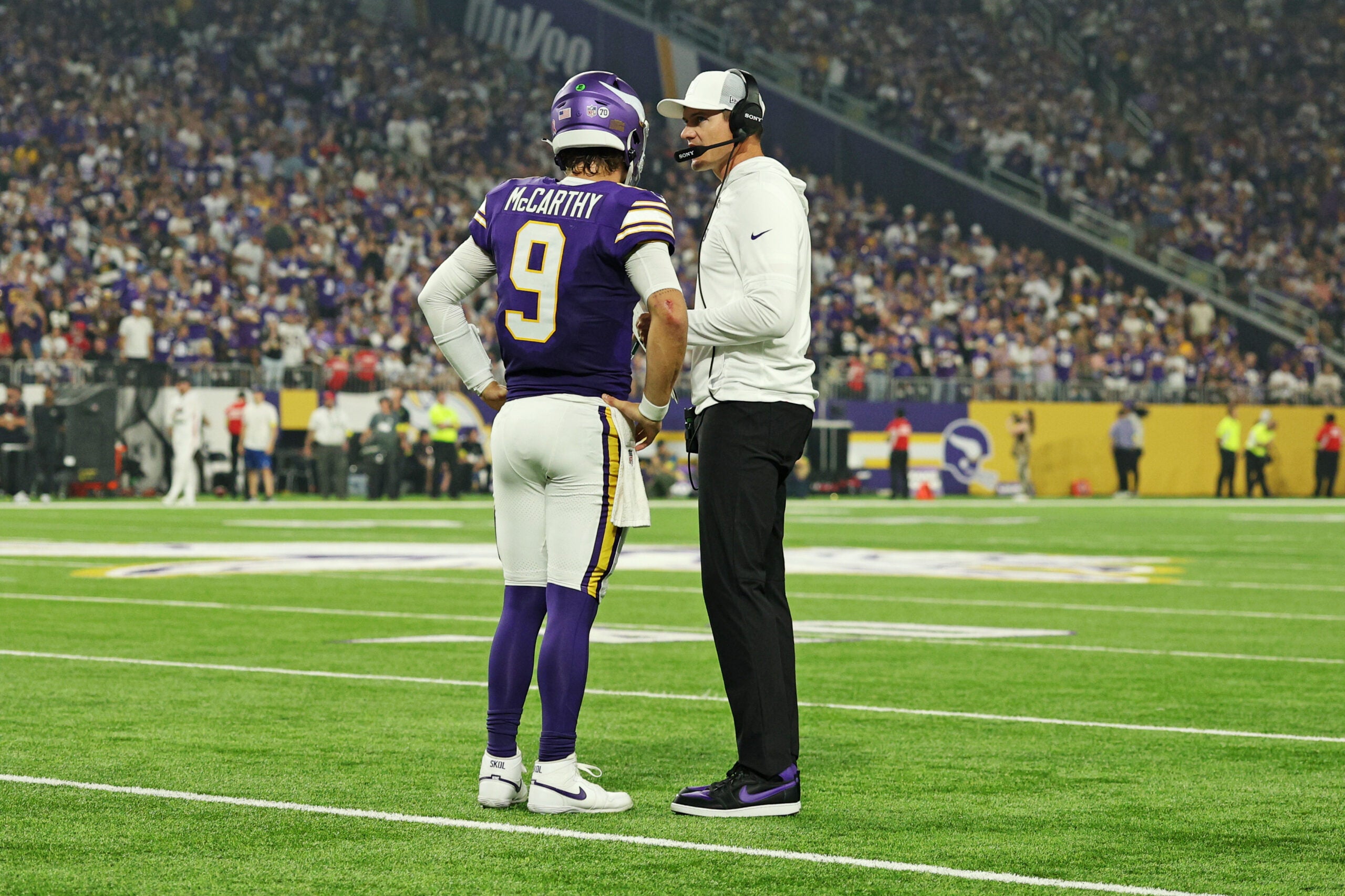 Sep 14, 2025; Minneapolis, Minnesota, USA; Minnesota Vikings quarterback J.J. McCarthy (9) speaks with Minnesota Vikings head coach Kevin O'Connell during the first half against the Atlanta Falcons at U.S. Bank Stadium.