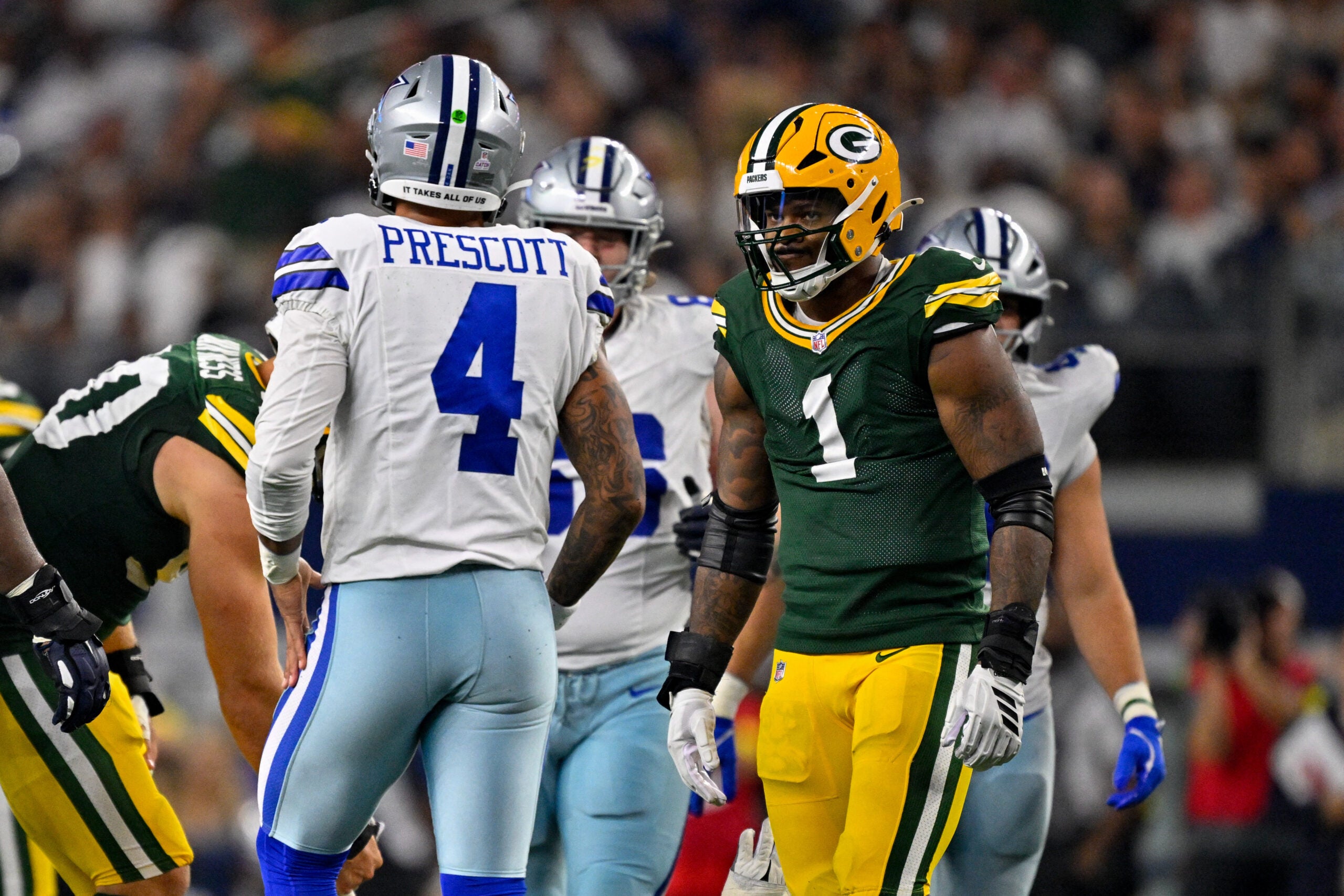 Sep 28, 2025; Arlington, Texas, USA; Green Bay Packers defensive end Micah Parsons (1) stares at Dallas Cowboys quarterback Dak Prescott (4) during the game between the Dallas Cowboys and the Green Bay Packers at AT&T Stadium.