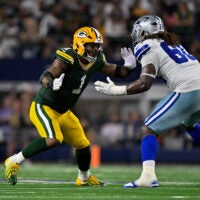 Sep 28, 2025; Arlington, Texas, USA; Dallas Cowboys offensive tackle Tyler Guyton (60) drops back to block the rush of Green Bay Packers defensive end Micah Parsons (1) during the game between the Dallas Cowboys and the Green Bay Packers at AT&T Stadium.
