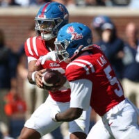 Oct 11, 2025; Oxford, Mississippi, USA; Mississippi Rebels quarterback Trinidad Chambliss (6) hands the ball off to running back Kewan Lacy (5) during the second quarter against the Washington State Cougars at Vaught-Hemingway Stadium.