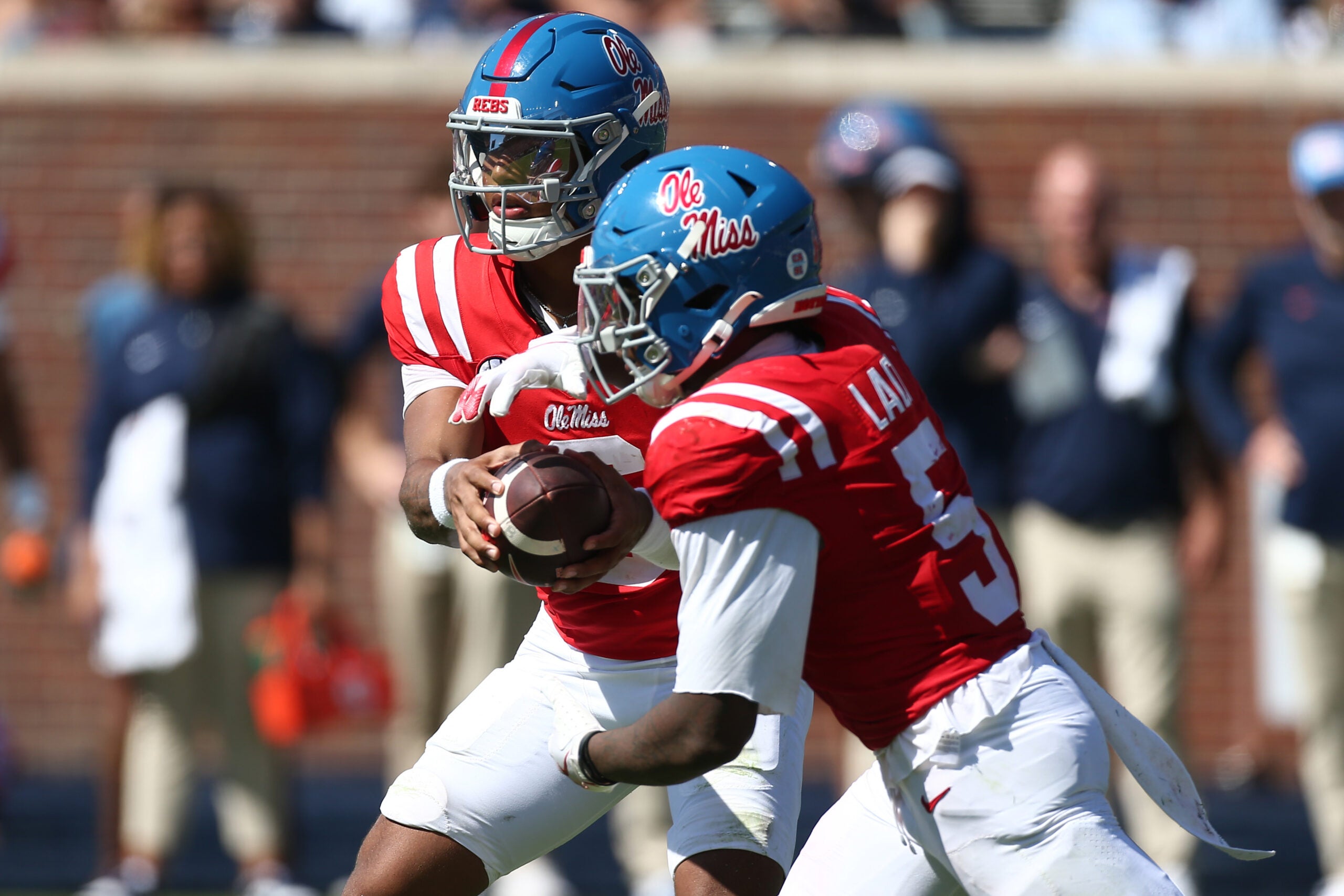 Oct 11, 2025; Oxford, Mississippi, USA; Mississippi Rebels quarterback Trinidad Chambliss (6) hands the ball off to running back Kewan Lacy (5) during the second quarter against the Washington State Cougars at Vaught-Hemingway Stadium.