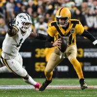 Oct 26, 2025; Pittsburgh, Pennsylvania, USA; Pittsburgh Steelers quarterback Aaron Rodgers (8) scrambles against Green Bay Packers defensive end Micah Parsons (1) during the first quarter at Acrisure Stadium.
