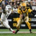 Oct 26, 2025; Pittsburgh, Pennsylvania, USA; Pittsburgh Steelers quarterback Aaron Rodgers (8) scrambles against Green Bay Packers defensive end Micah Parsons (1) during the first quarter at Acrisure Stadium.