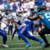 Oct 26, 2025; Charlotte, North Carolina, USA; Buffalo Bills running back James Cook III (4) with the ball as Carolina Panthers linebacker Nic Scourton (11) and linebacker Christian Rozeboom (56) defend in the first quarter at Bank of America Stadium.