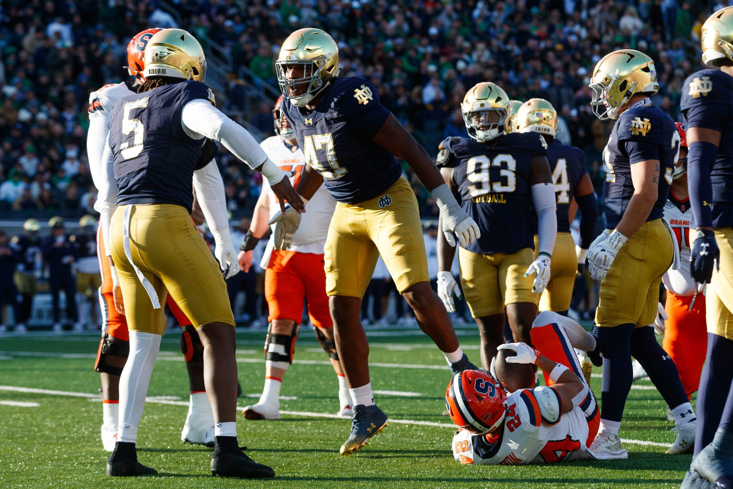 Notre Dame defensive lineman Jason Onye (47) celebrates tackling Syracuse running back Will Nixon (24) in the first half of a NCAA football game at Notre Dame Stadium on Saturday, Nov. 22, 2025, in South Bend.