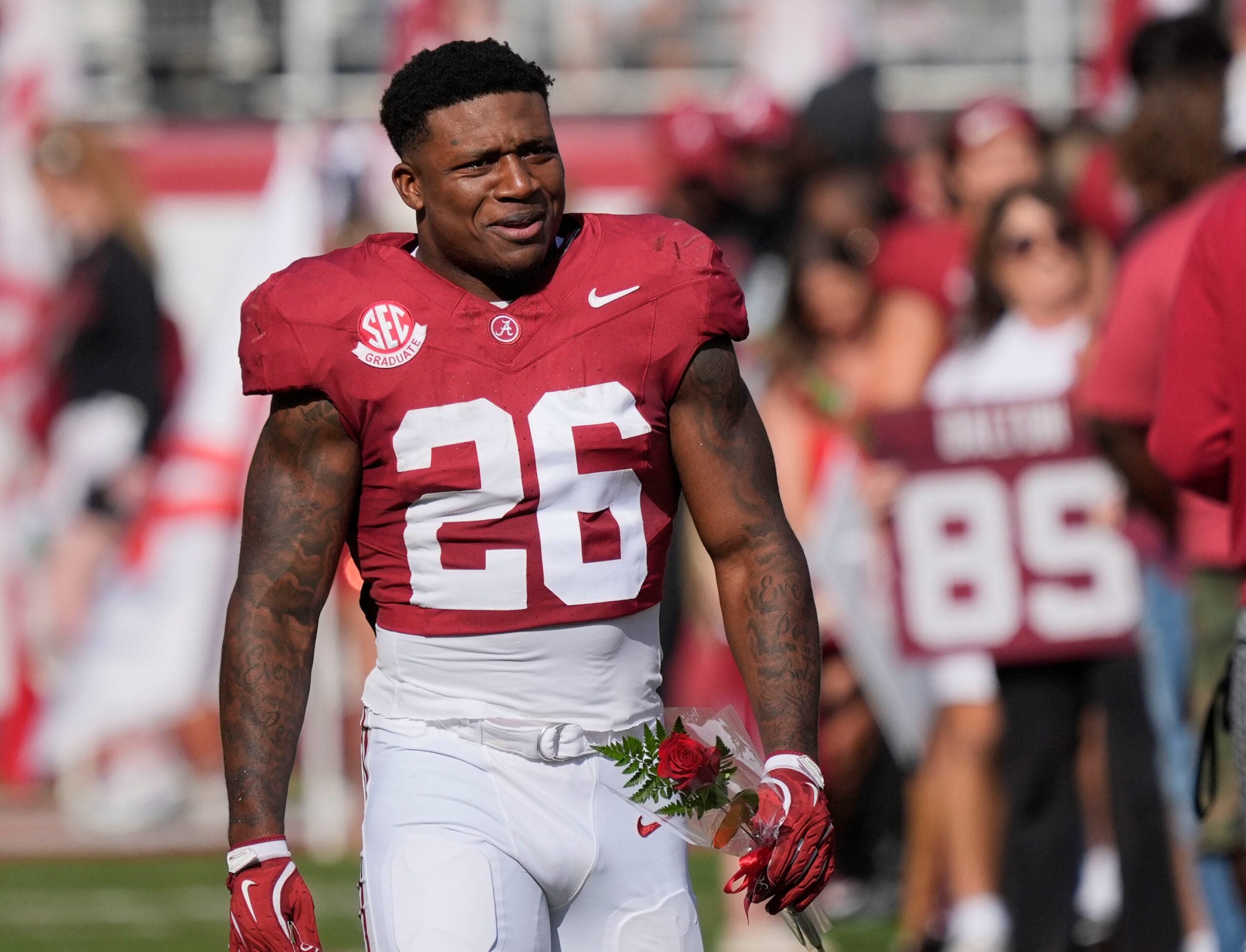 Nov 22, 2025; Tuscaloosa, Alabama, USA; Alabama running back Jam Miller (26) walks to his family with a rose in hand on Senior Day at Saban Field at Bryant-Denny Stadium.