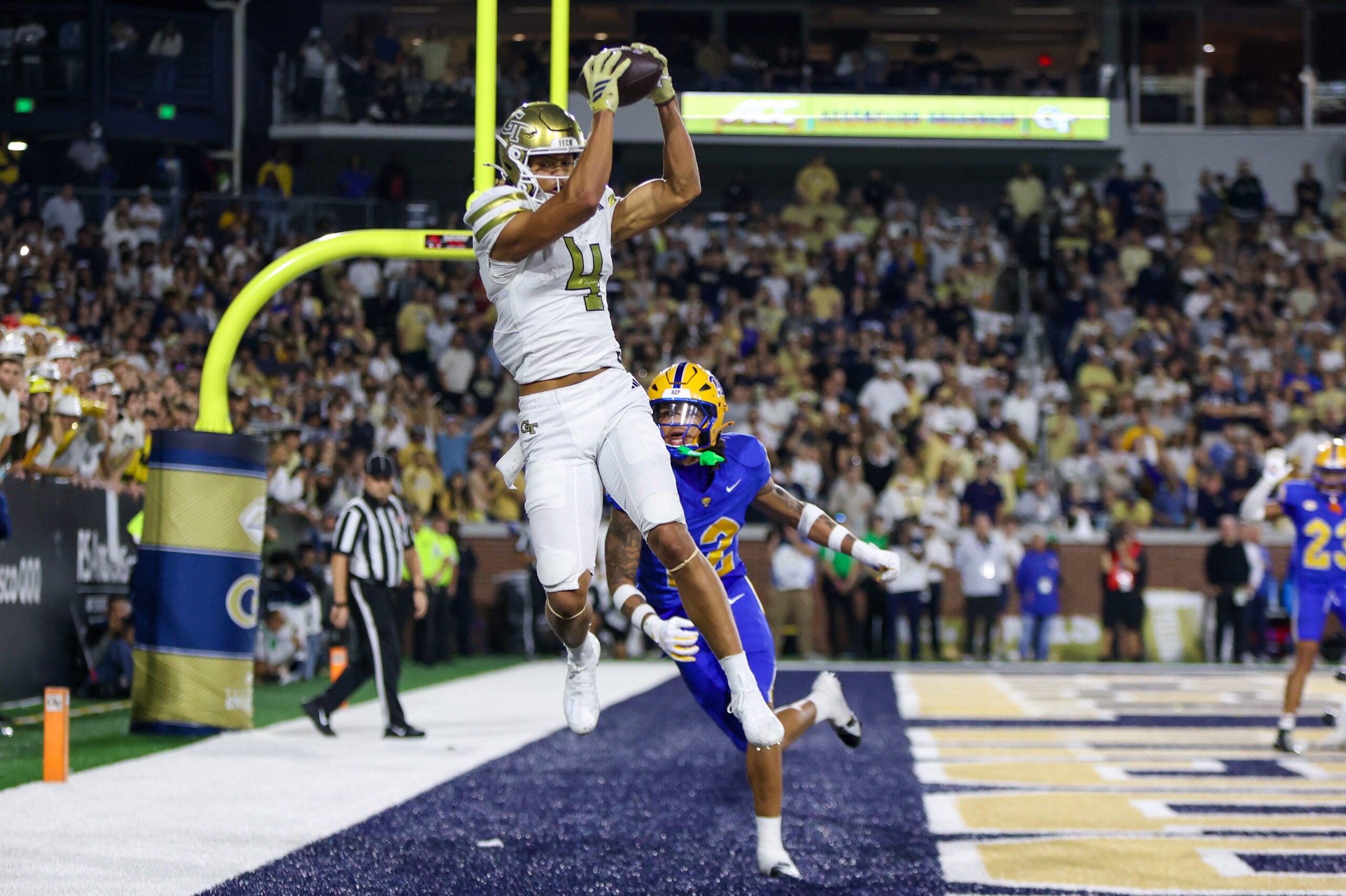 Nov 22, 2025; Atlanta, Georgia, USA; Georgia Tech Yellow Jackets wide receiver Isiah Canion (4) catches a touchdown pass against the Pittsburgh Panthers in the fourth quarter at Bobby Dodd Stadium at Hyundai Field.