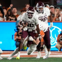 Nov 28, 2025; Austin, Texas, USA; Texas A&M Aggies quarterback Marcel Reed (10) keeps the ball for yards during the first half against the Texas Longhorns at Darrell K Royal-Texas Memorial Stadium.
