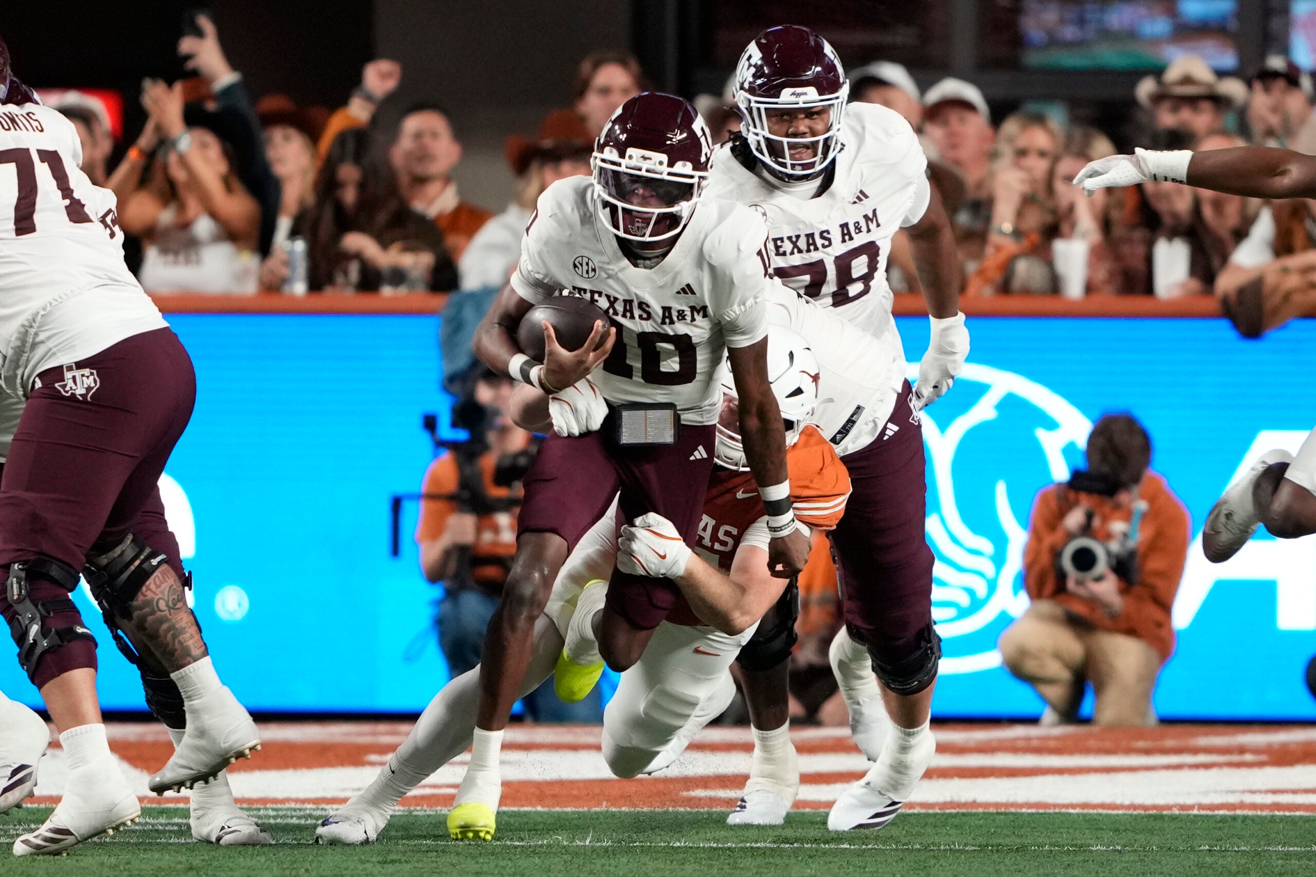 Nov 28, 2025; Austin, Texas, USA; Texas A&M Aggies quarterback Marcel Reed (10) keeps the ball for yards during the first half against the Texas Longhorns at Darrell K Royal-Texas Memorial Stadium.