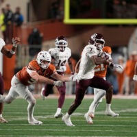 Nov 28, 2025; Austin, Texas, USA; Texas A&M Aggies wide receiver KC Concepcion (7) returns a punt while defended by defensive lineman Ethan Burke (91) during the first half against the Texas Longhorns at Darrell K Royal-Texas Memorial Stadium.