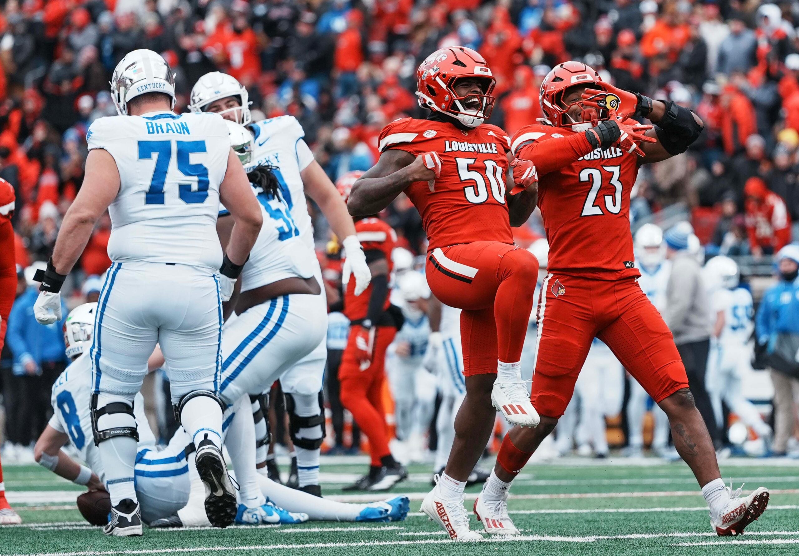 Louisville Cardinals defensive lineman Clev Lubin (50) celebrates his sack of Kentucky quarterback Cutter Boley with Louisville Cardinals defensive lineman Wesley Bailey (23) as the Cards roll past the Cats 41-0 Saturday, November 29, 2025.
