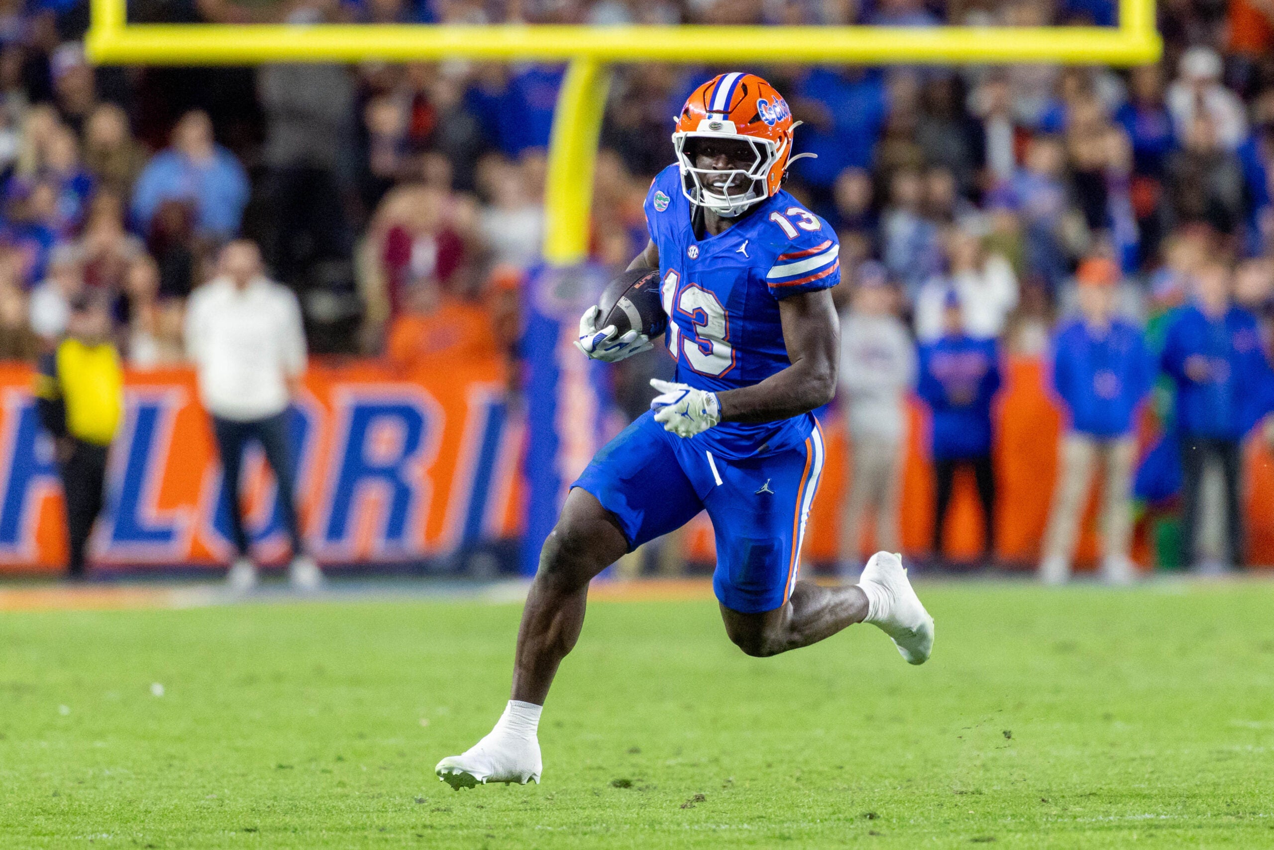 Nov 29, 2025; Gainesville, Florida, USA; Florida Gators running back Jadan Baugh (13) runs with the ball during the third quarter against the Florida State Seminoles at Ben Hill Griffin Stadium.