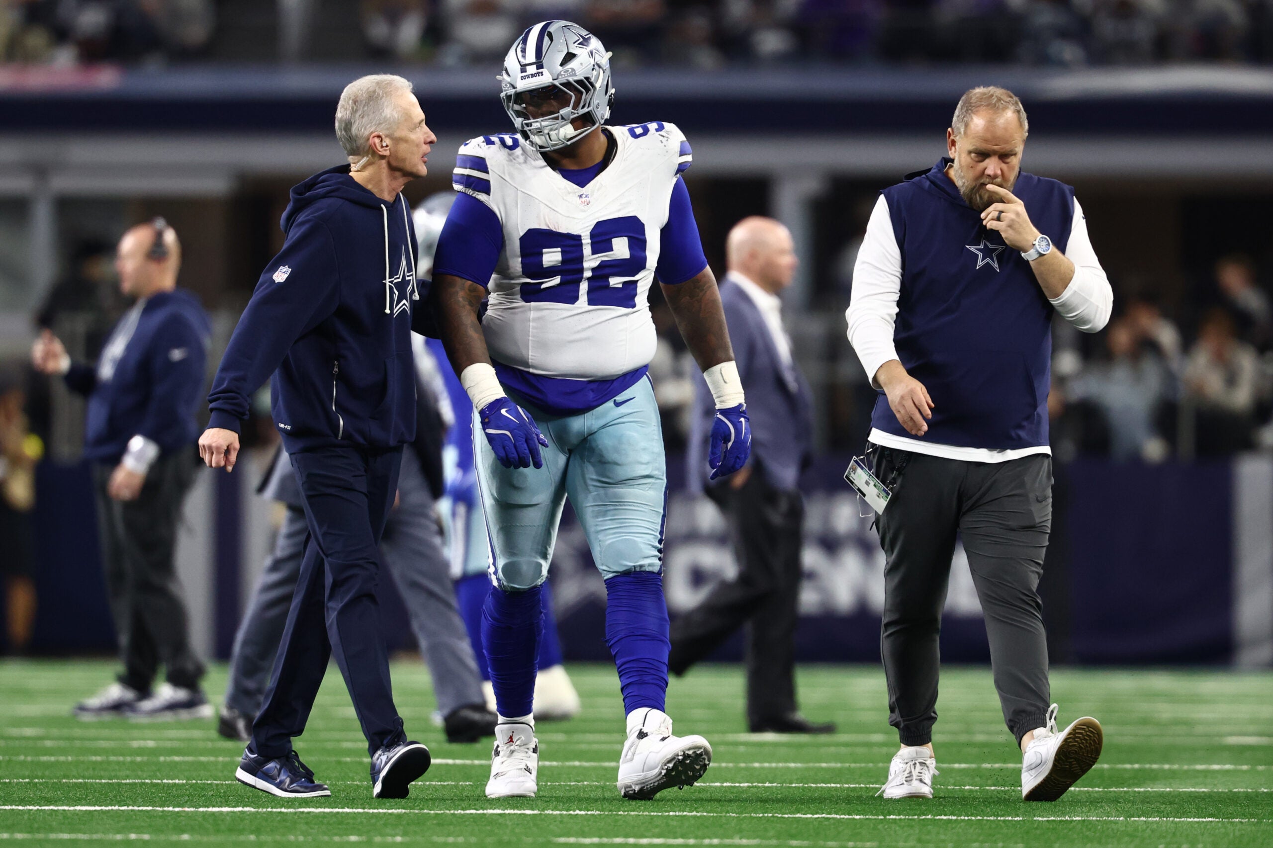 Dec 14, 2025; Arlington, Texas, USA; Dallas Cowboys defensive tackle Quinnen Williams (92) walks off the field with trainers after an injury during the second half against the Minnesota Vikings at AT&T Stadium.