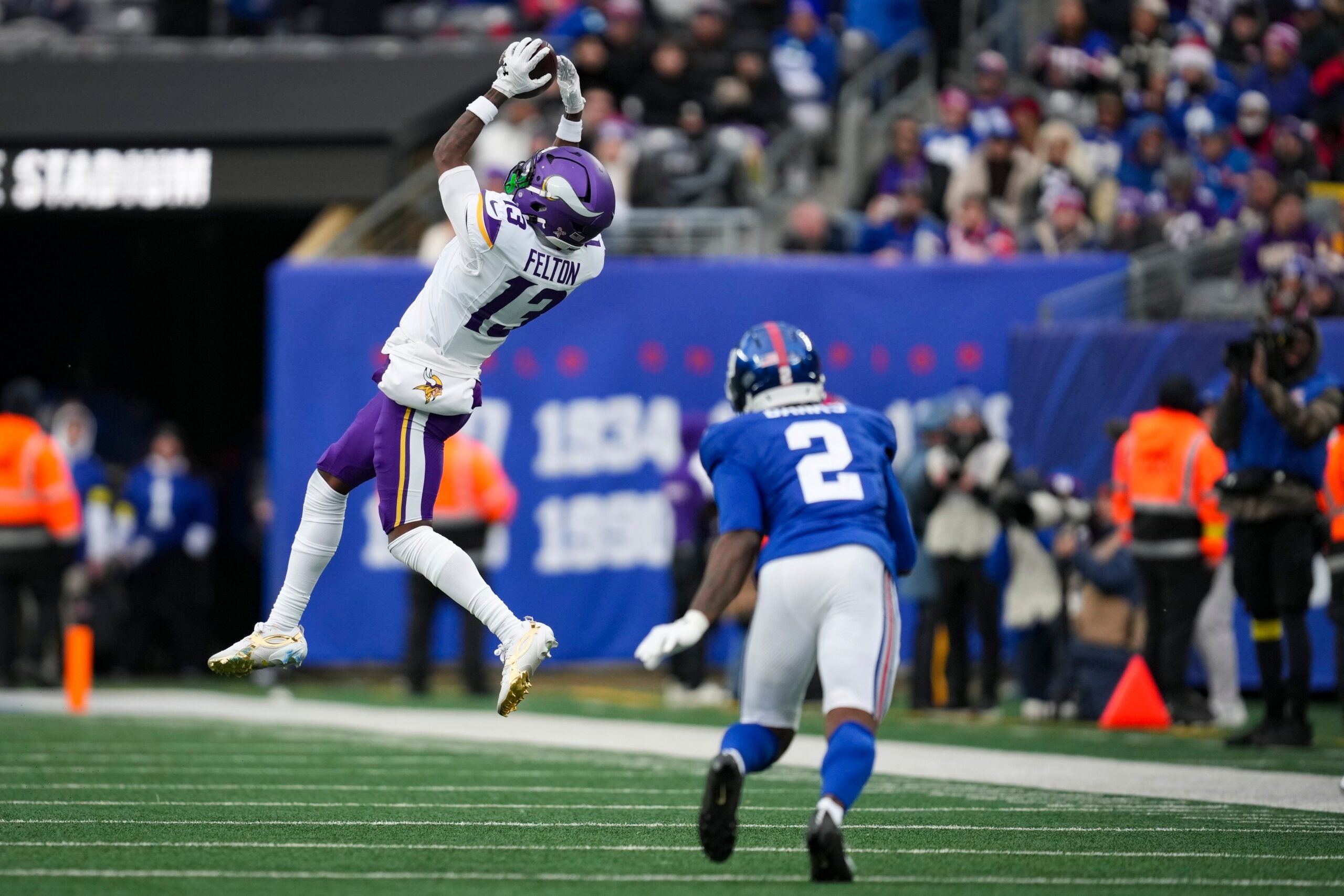 Minnesota Vikings wide receiver Tai Felton (13) catches the ball as New York Giants cornerback Deonte Banks (2) defends during a game at MetLife Stadium, Dec 21, 2025, East Rutherford, NJ, USA