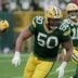 Green Bay Packers offensive tackle Zach Tom (50) leads a running back during the third quarter of their game against the Minnesota Vikings Sunday, November 23, 2025 at Lambeau Field in Green Bay, Wisconsin.