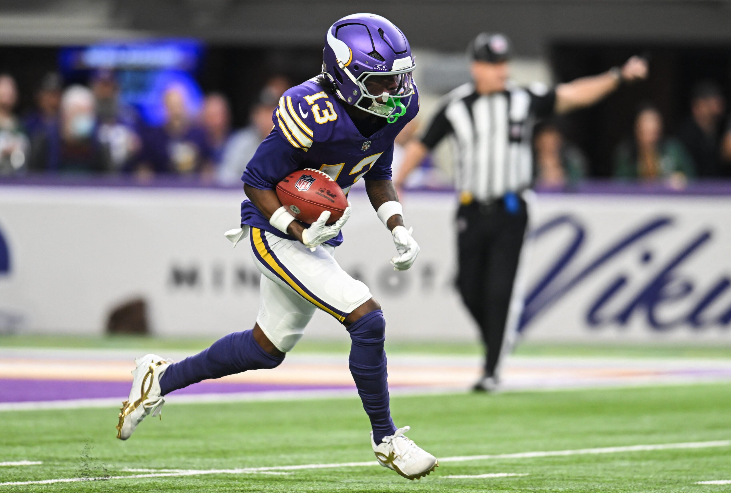 Jan 4, 2026; Minneapolis, Minnesota, USA; Minnesota Vikings wide receiver Tai Felton (13) returns the ball against the Green Bay Packers during the first quarter at U.S. Bank Stadium.