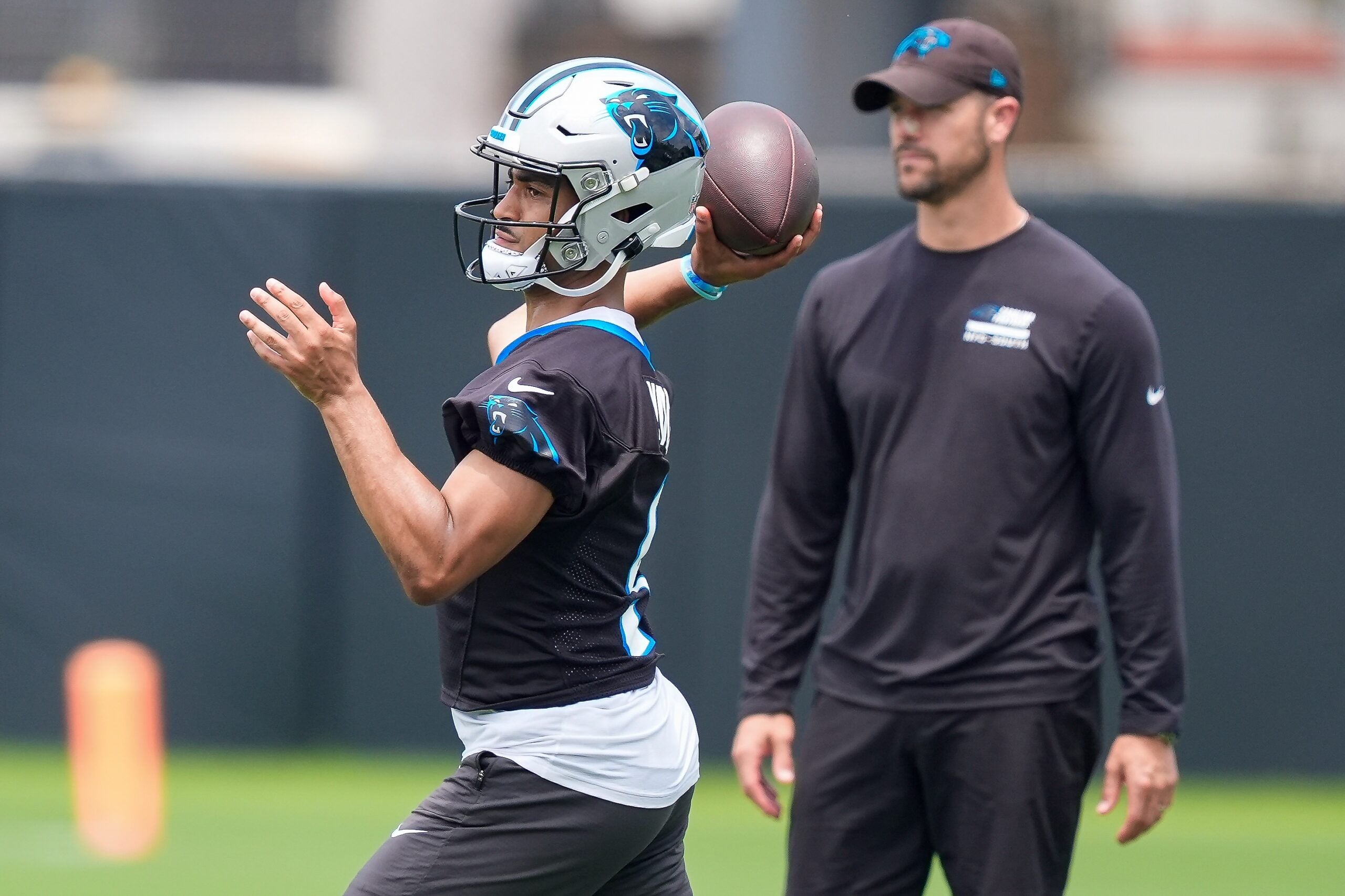 Jun 9, 2026; Charlotte, NC, USA; Carolina Panthers quarterback Bryce Young (9) throws in front of head coach Dave Canales during the first day of mini camp at Bank of America Stadium practice facility.