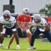 Jul 28, 2026; Foxborough, MA, USA; New England Patriots offensive lineman Jared Wilson (55) and guard Alijah Vera-Tucker (75) do a drill with quarterback Drake Maye (10) during training camp at Gillette Stadium.