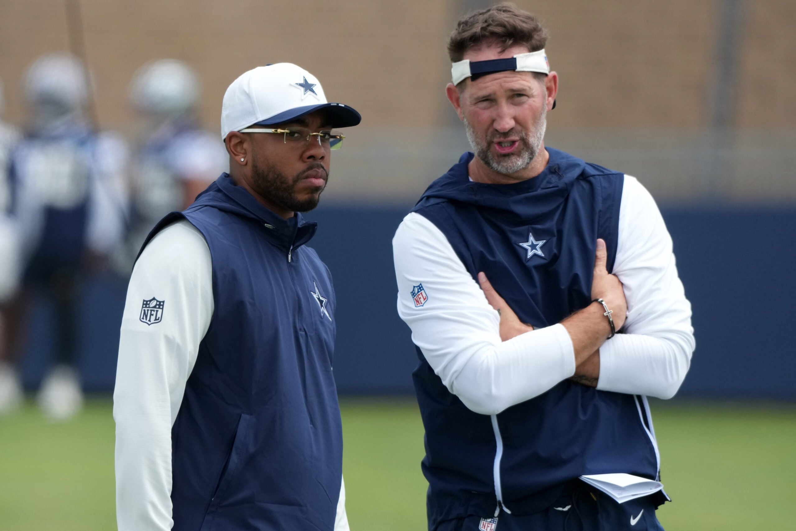 Jul 29, 2026; Oxnard, CA, USA; Dallas Cowboys defensive coordinator Christian Parker (left) with head coach Brian Schottenheimer at training camp at River Ridge Playing Fields.