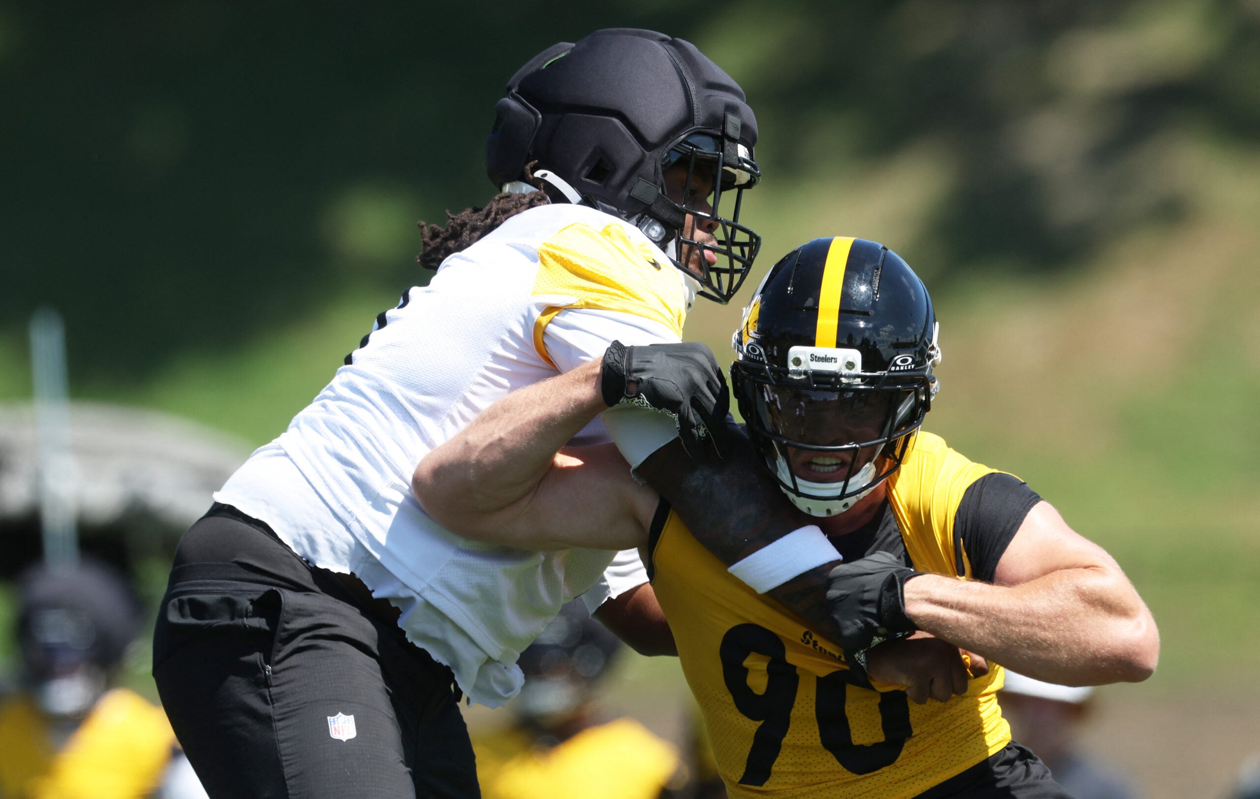 Jul 30, 2026; Latrobe, PA, USA; Pittsburgh Steelers linebacker T.J. Watt (90) works against offensive tackle Max Iheanachor (left) during training camp drills at Saint Vincent College.