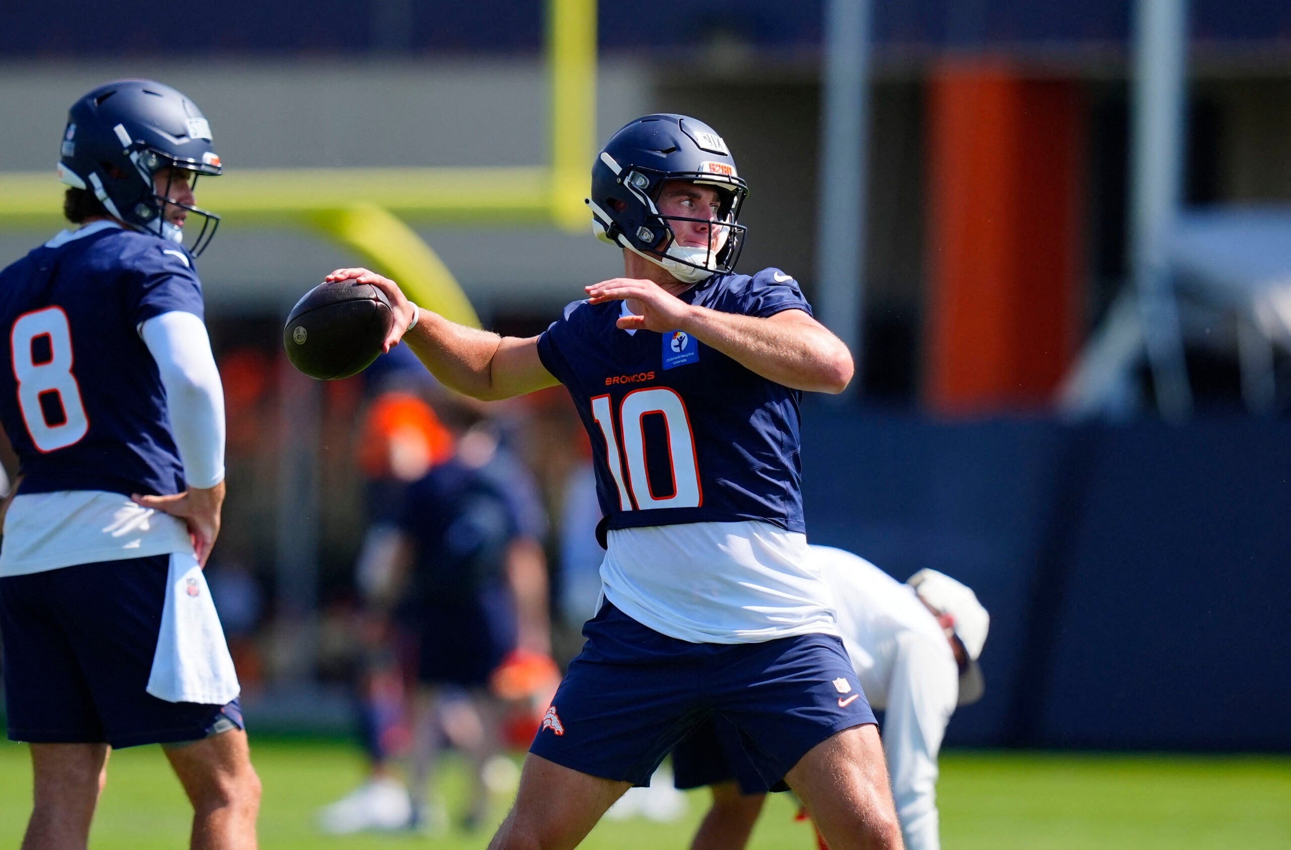 Jul 31, 2026; Englewood, CO, USA; Denver Broncos quarterback Bo Nix (10) prepares to pass the ball during training camp at Broncos Park.