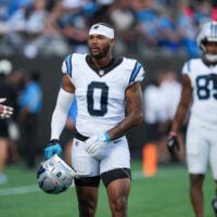 Jul 31, 2026; Charlotte, NC, USA; Carolina Panthers tight end Ja’Tavion Sanders (0) walks on the field while holding his helmet during Fanfest at Bank of America Stadium.
