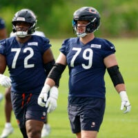 Jul 31, 2026; Lake Forest, IL, USA; Chicago Bears offensive tackle Kiran Amegadjie (72) and offensive tackle Theo Benedet (79) walk on the field during Training Camp at Halas Hall.