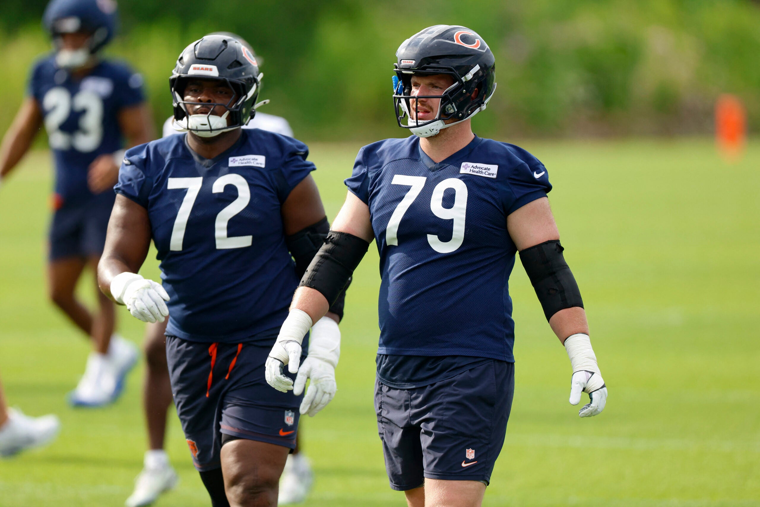 Jul 31, 2026; Lake Forest, IL, USA; Chicago Bears offensive tackle Kiran Amegadjie (72) and offensive tackle Theo Benedet (79) walk on the field during Training Camp at Halas Hall.