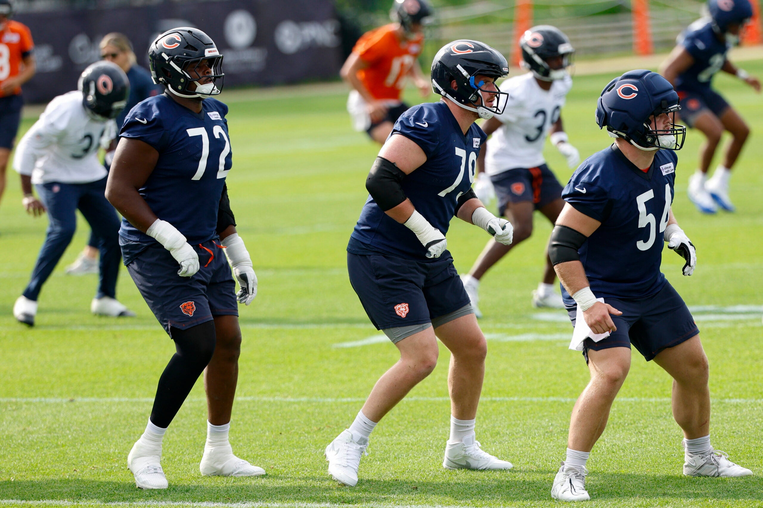 Jul 31, 2026; Lake Forest, IL, USA; Chicago Bears offensive tackle Kiran Amegadjie (72), offensive tackle Theo Benedet (79) and offensive lineman Logan Jones (54) warm up during Training Camp at Halas Hall.