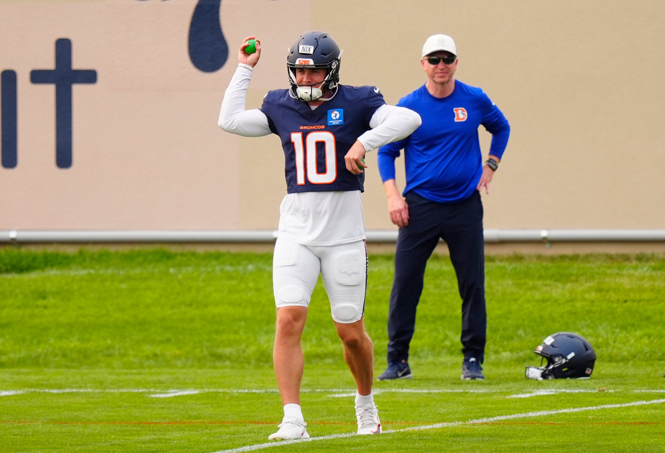 Aug 3, 2026; Englewood, CO, USA; Denver Broncos quarterback Bo Nix (10) warms up during training camp at Broncos Park.