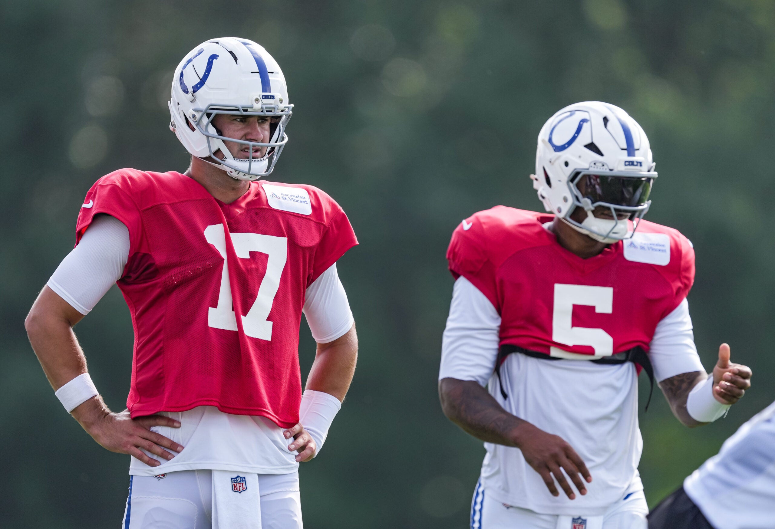 Indianapolis Colts quarterback Daniel Jones (17) waits between drills with Indianapolis Colts quarterback Anthony Richardson Sr. (5) on Monday, Aug. 3, 2026, during practice at Colts Camp at Grand Park in Westfield.