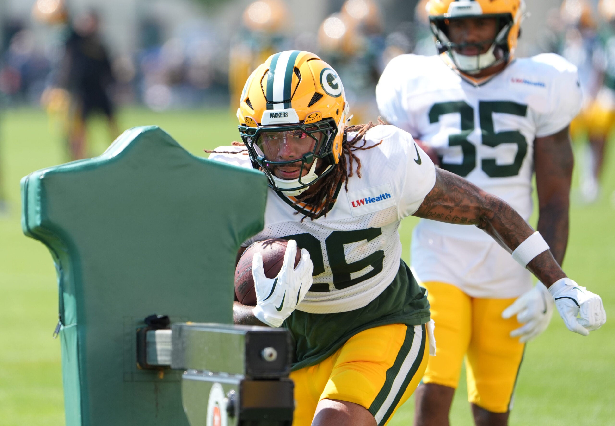 Green Bay Packers running back Damien Martinez (26) participates in a drill during the fifth day of training camp on Aug. 3, 2026, at Ray Nitschke Field in Ashwaubenon, Wis.