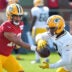 Green Bay Packers quarterback Jordan Love (10) hands off the ball to running back Josh Jacobs (8) during the fifth day of training camp on Aug. 3, 2026, at Ray Nitschke Field in Ashwaubenon, Wis.