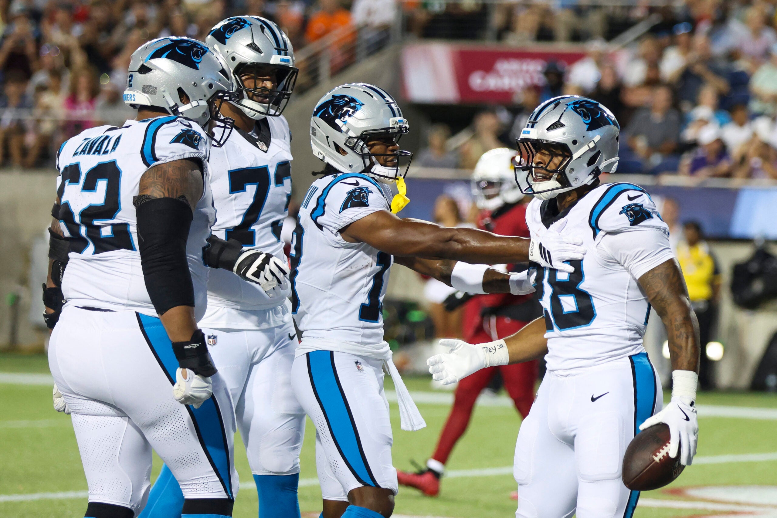 Aug 6, 2026; Canton, Ohio, USA; Carolina Panthers running back AJ Dillon (28) celebrates with teammates after scoring a touchdown against the Arizona Cardinals in the second quarter at Tom Benson Hall of Fame Stadium.