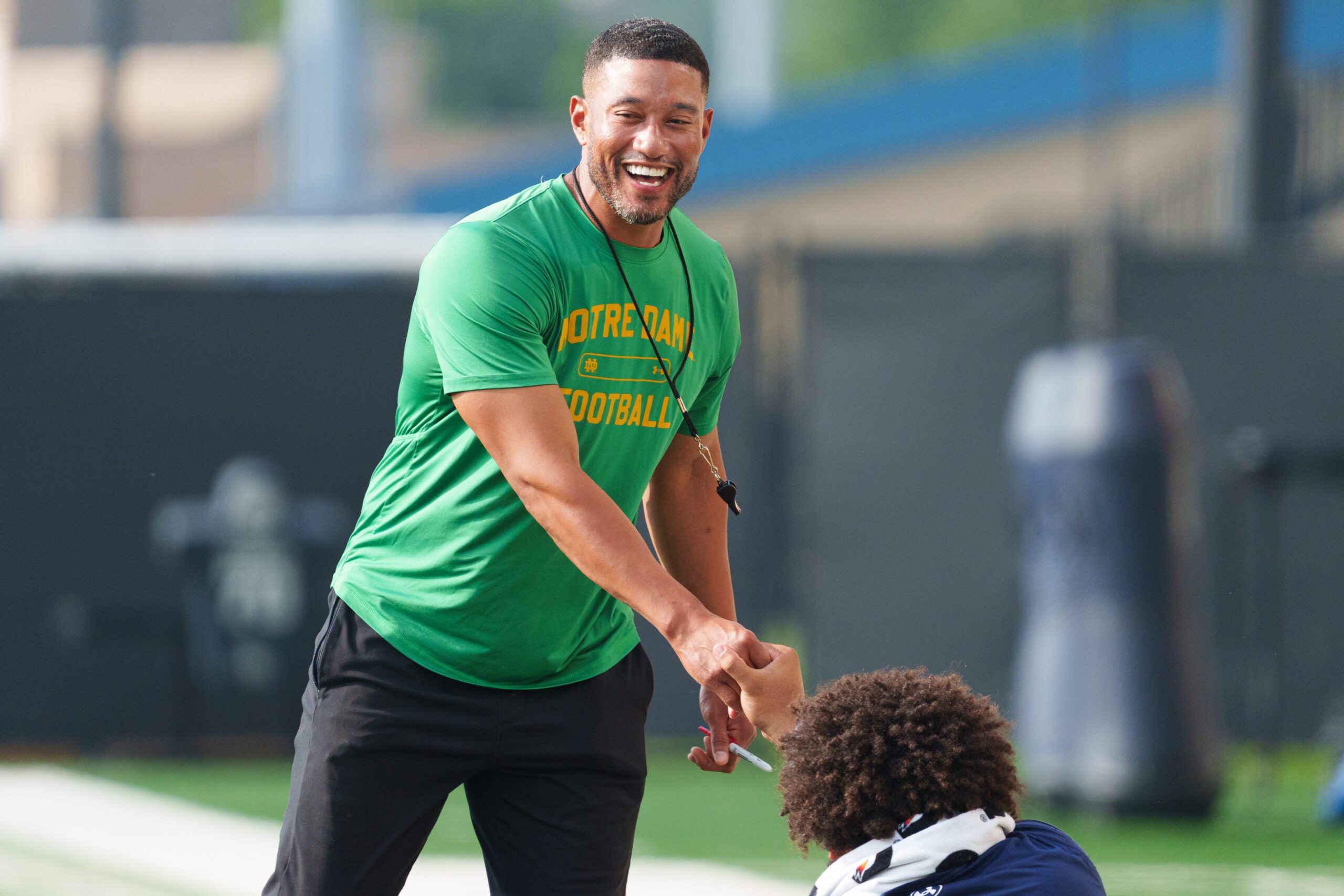 Head coach Marcus Freeman shakes hands with one of his players during a Notre Dame football practice at Irish Athletic Center on Saturday, Aug. 8, 2026, in South Bend.