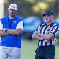 Florida Head Coach Jon Sumrall, left, watches practice with referees at Heavener Football Complex in Gainesville, FL on Tuesday, August 11, 2026.