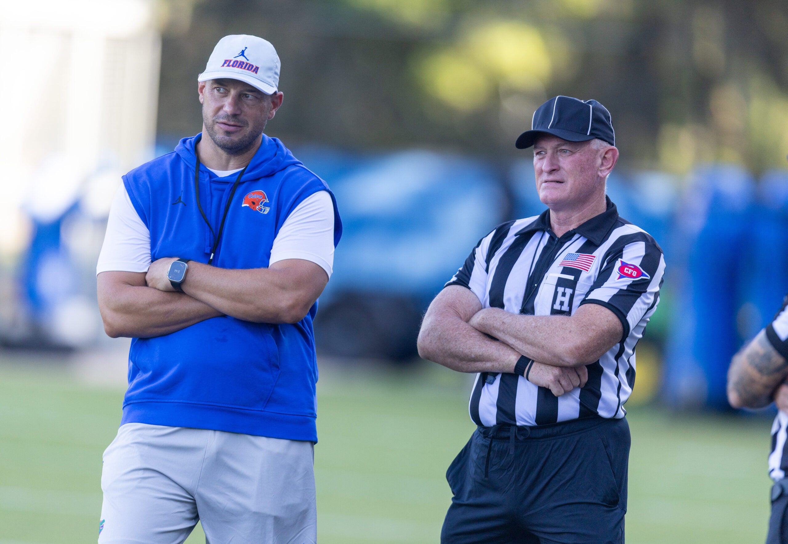 Florida Head Coach Jon Sumrall, left, watches practice with referees at Heavener Football Complex in Gainesville, FL on Tuesday, August 11, 2026.