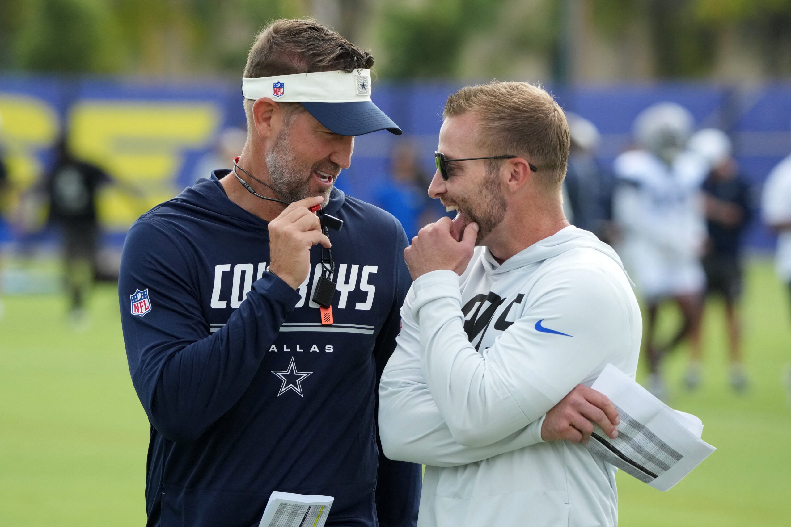 Aug 11, 2026; Woodland Hills, CA, USA; Dallas Cowboys head coach Brian Schottenheimer (left) and Los Angeles Rams head coach Sean McVay react during a joint practice at the Rams Practice Facility.