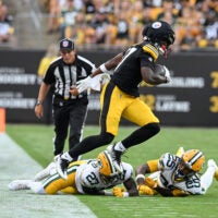 Aug 13, 2026; Pittsburgh, Pennsylvania, USA; Pittsburgh Steelers wide receiver Germie Bernard (17) jumps over Green Bay Packers safety Kitan Oladapo (27) during the first half of a game against the Green Bay Packers at Acrisure Stadium.