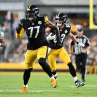 Aug 13, 2026; Pittsburgh, Pennsylvania, USA; Pittsburgh Steelers offensive tackle Broderick Jones (77) looks for someone to block as tight end Robert Tonyan (83) carries the ball during the first half of a game against the Green Bay Packers at Acrisure Stadium.