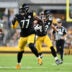 Aug 13, 2026; Pittsburgh, Pennsylvania, USA; Pittsburgh Steelers offensive tackle Broderick Jones (77) looks for someone to block as tight end Robert Tonyan (83) carries the ball during the first half of a game against the Green Bay Packers at Acrisure Stadium.